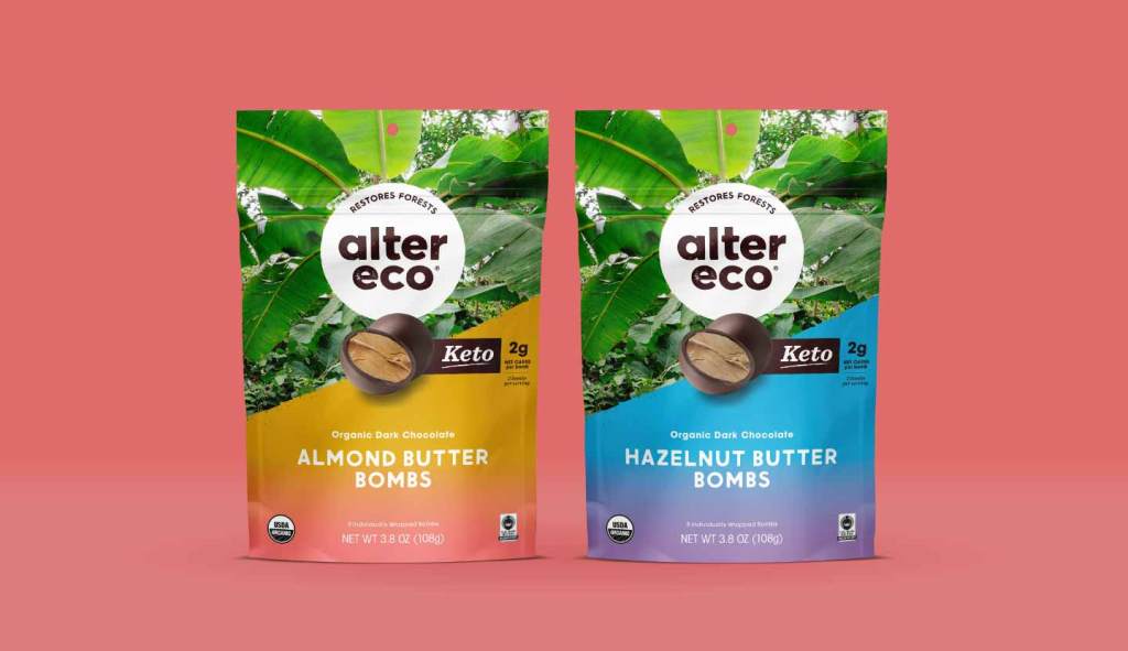 Image of 2 bags of Alter Eco nut butter bombs in front of a salmon pink background. The bag on the left is Almond Butter Bombs and the bag on the right is Hazelnut Butter bombs.